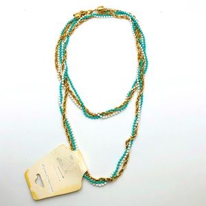 Fashion jewelry necklace gold/ light blue/ white stands.